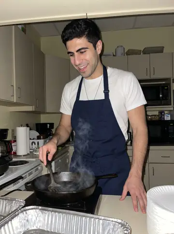 Adrián, AI character: the precinct break room kitchenette on the first of the month, foil pans and paper plates on the counter