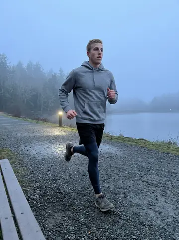 Harrison, AI character: the gravel loop around a small reservoir at 5am, phone propped on a bench