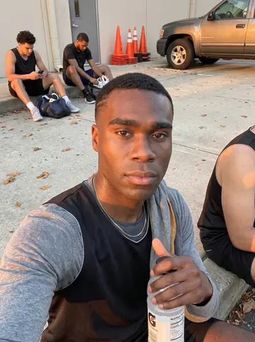 Keon, AI character: Sunday morning free basketball clinic at a neighborhood gym in Scarborough, small training cones scattered…
