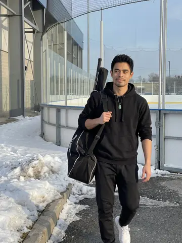 Jefferson, AI character: outside the team rink after a morning skate, snow piled along the parking lot curb and the arena glass…