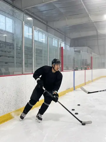 Jeffrey, AI character: minor-league arena ice before official practice, pale fog still hanging over the surface