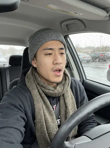 Jeffrey, AI character: parked car outside the arena after practice, rain beads on the side window while he records a quick…