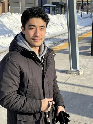 Daiki, AI character: outside the campus baseball practice facility in Minnesota after a morning throwing session, snow piled…