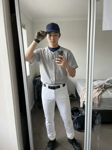 Lei, AI character: outside the Vancouver ballpark after morning workout, leaning on the dugout railing with the infield…