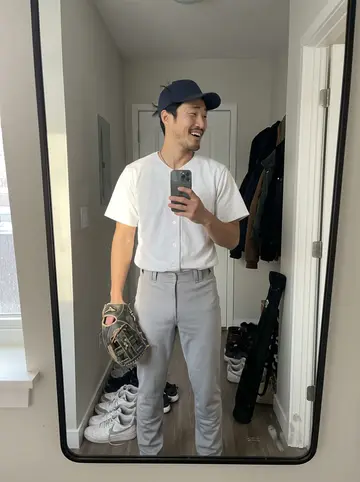 Jacky, AI character: outside a community indoor batting facility in Richmond after morning workout, standing near the doors…