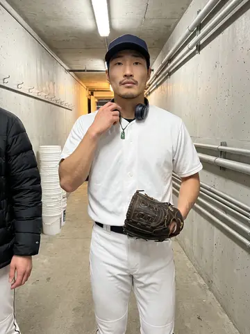 Jacky, AI character: inside the minor-league team's indoor training facility during evening practice, turf scuffed and empty…