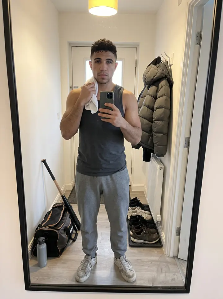 Gerardo, AI character: outside an indoor batting cage facility in Worcester just after early practice, leaning against the…