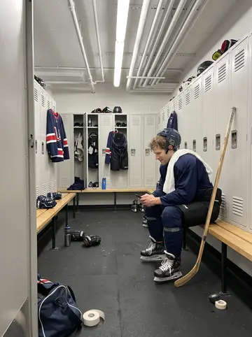 Blaine, AI character: a small Thunder Bay karaoke bar after an away-game win, neon beer signs and a scratched wood table behind him