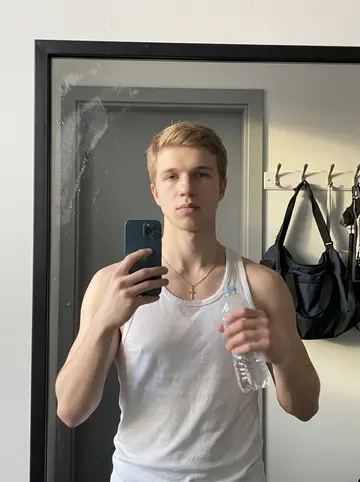 Yaroslav, AI character: the athletic training room after evening lift, with padded tables, ice bags and lockers in the background