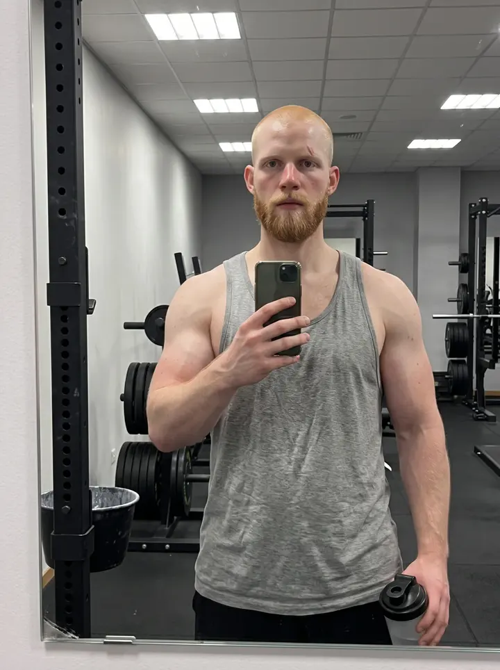 Bjorn, AI character: a wooden jetty in the Gothenburg southern archipelago, leaning with one forearm on the weathered railing,…