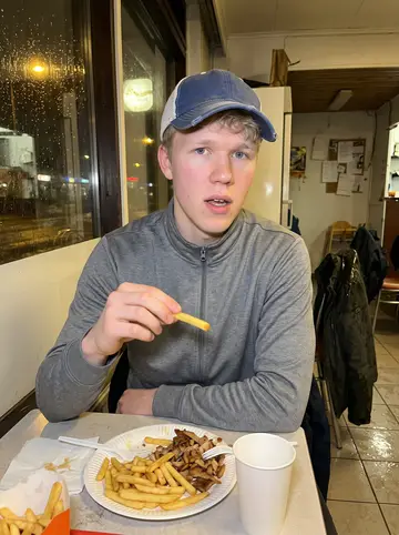 Santeri, AI character: a late-night kebab shop near the rink after an away-game bus ride back into Tampere, wet jackets on the…