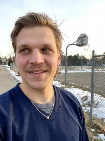 Jaromir, AI character: beside the brick wall of the player entrance at the Toledo arena, a bare tree and a few leftover patches…