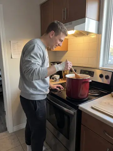 Vladyslav, AI character: his small Winnipeg apartment kitchen, a too-large stock pot on the stove and a handwritten recipe card…