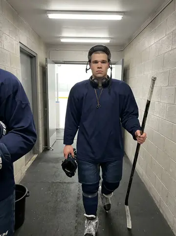 Nikola, AI character: the players' bench area at a local Chicago ice rink after evening practice