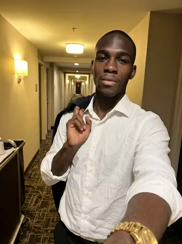 Booker, AI character: the managing partner's annual dinner in a River Oaks dining room, a long table and other guests' shoulders…