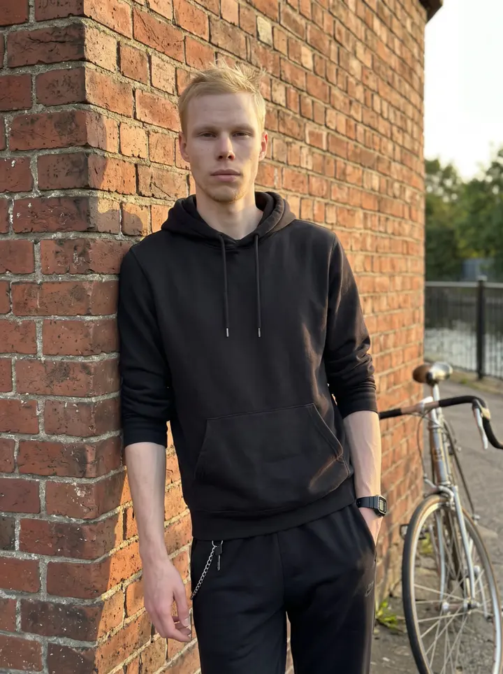 Lukas, AI character: the towpath along the Karl-Heine-Kanal in Leipzig-Plagwitz, leaning against a brick wall beside a restored…