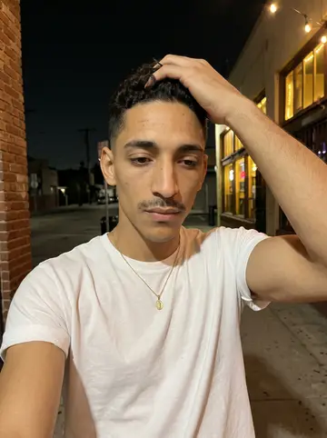 Ignacio, AI character: inside the barber shop in Boyle Heights where he rents a chair, mirrors and a rack of clippers on the wall…