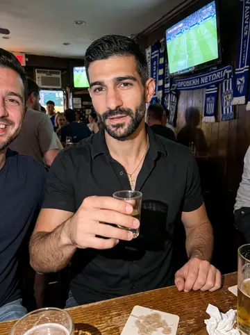 Vyronas, AI character: a crowded Greek bar in Astoria during a late football match, blue-and-white scarves and a television glow…