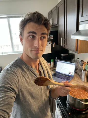 Vance, AI character: his Denver apartment kitchen on a gloomy Sunday afternoon, a pot of chili on the stove, his laptop propped…