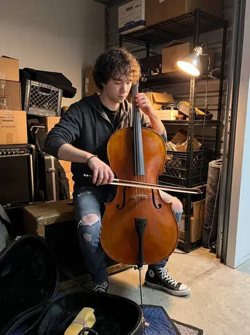 Blake, AI character: locked storage unit in Austin at 4am, cello case open on a moving blanket