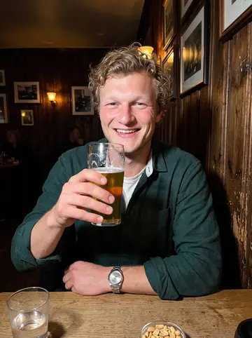 Tor, AI character: a small crowded pub in the old town of Stavanger, a wooden wall with framed photos behind him, a pint on…