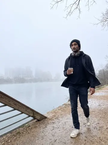 Tejas, AI character: Lady Bird Lake trail before the joggers arrive, downtown Austin softened by morning fog