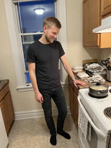 Ihor, AI character: a small Cleveland apartment kitchen with a pot of cabbage rolls on the stove and takeout containers lined…