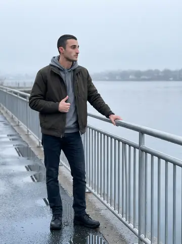 Brando, AI character: India Point Park near the Providence harbor before most people are awake, damp walkway and quiet water…