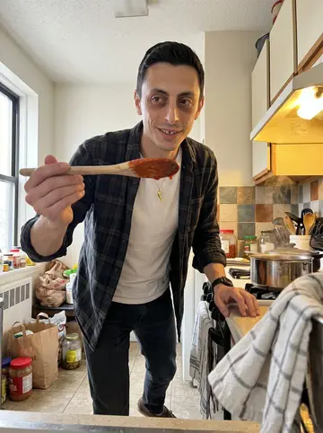 Onofrio, AI character: his mother's apartment kitchen on a Sunday morning, a pot of red sauce simmering on the stove and grocery…
