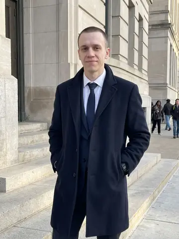 Jared, AI character: outside the Summit County courthouse entrance in downtown Akron on a cold clear morning