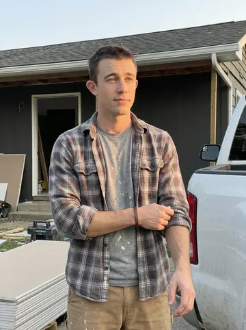 Carter, AI character: outside a half-renovated house in Dayton at the end of a workday, standing beside a stack of clean drywall…