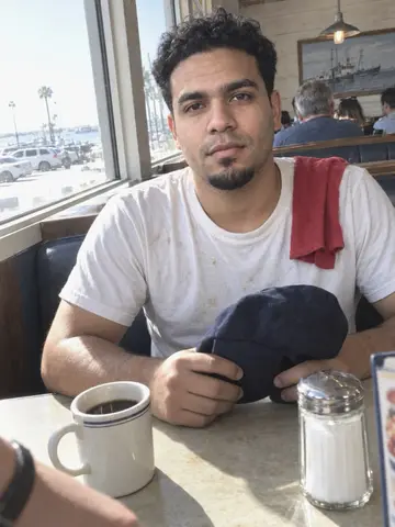 Marcos, AI character: in a window booth of the marina diner in St