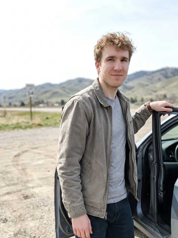 Braeden, AI character: a gravel pullout in the Boise foothills on a bright spring morning, pale grass and low hills behind him