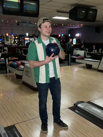 Milo, AI character: an old bowling alley on Thursday night, scoring screens and polished lanes behind him