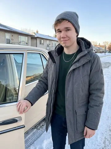 Fyodor, AI character: a quiet Winnipeg side street beside his old cream-colored Lada, packed snow along the curb and low winter…