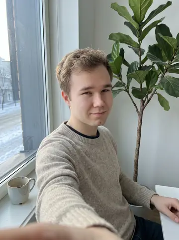 Fyodor, AI character: his apartment window corner with a very tall fig tree behind him and a chipped mug on the sill