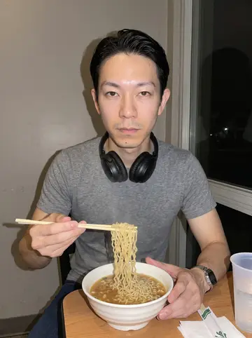 Vincent, AI character: a late-night noodle shop in Rowland Heights, small table by the window with a bowl of instant noodles and…