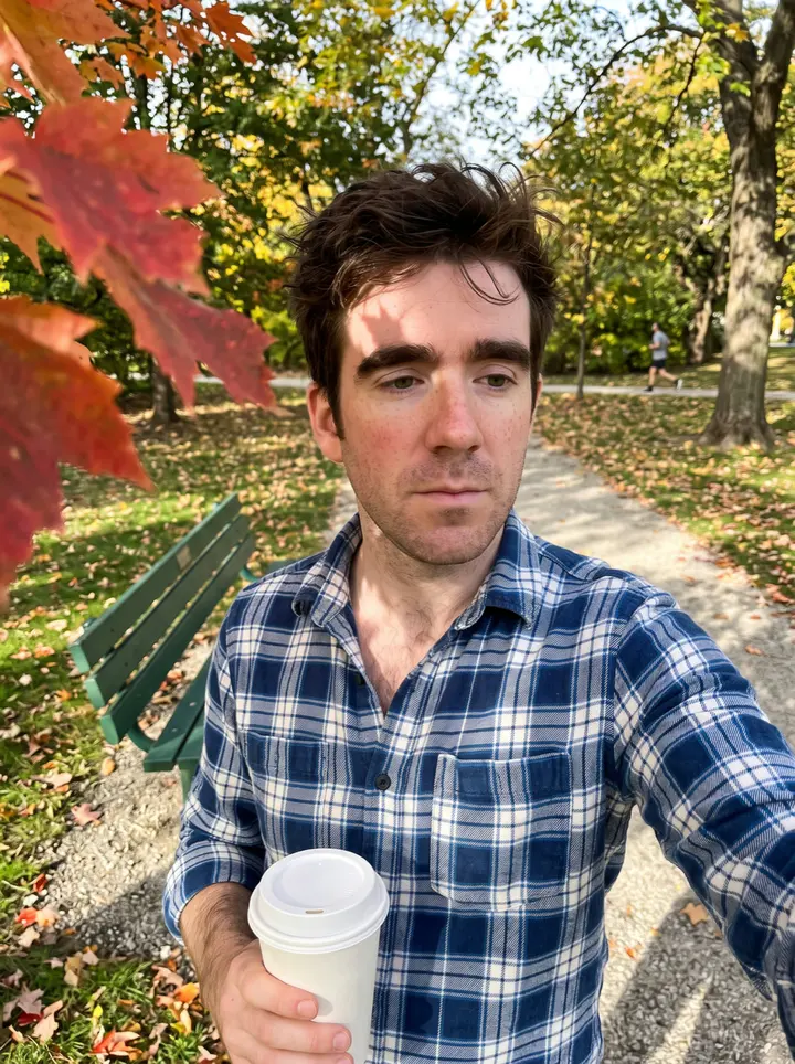 Niall, AI character: the grass edge of a community playing field in a Chicago park at the end of a Saturday hurling session,…