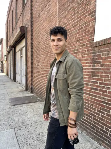 Bruno, AI character: outside an old brick warehouse in the Ironbound, Newark, after taking photos of empty storefronts