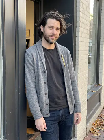 Hayden, AI character: outside the tall windows of his Portland workshop building near the Old Port, late afternoon after…