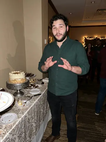 Brady, AI character: a hotel event room in Louisville at his ex's engagement party, standing near the dessert table after…