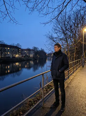 Pascal, AI character: the Weisse Elster riverside path after closing time, bare winter branches and apartment lights across the…