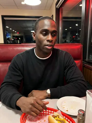 Junior, AI character: a late-night coney diner booth on the east side after helping his little brother with a ride