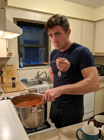 Gavin, AI character: the firehouse kitchen late in a winter shift, a big stockpot of chili on the stove and mismatched mugs on…