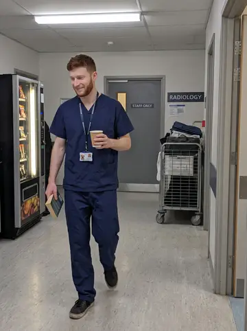 Benedikt, AI character: hospital staff corridor outside the radiology department during a quiet night shift break