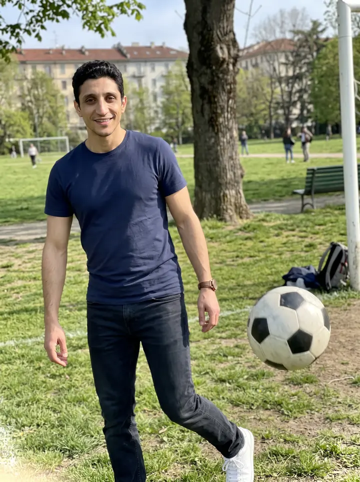 Stelvio, AI character: Parco del Valentino in Turin, on a sunny spring afternoon near the grass pitches, a football just kicked…