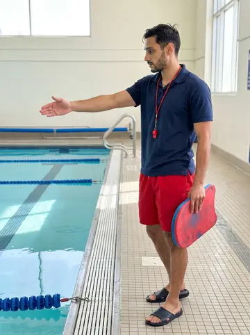 Rogelio, AI character: the shallow end of the Alameda rec center pool during a quiet weekday lesson block