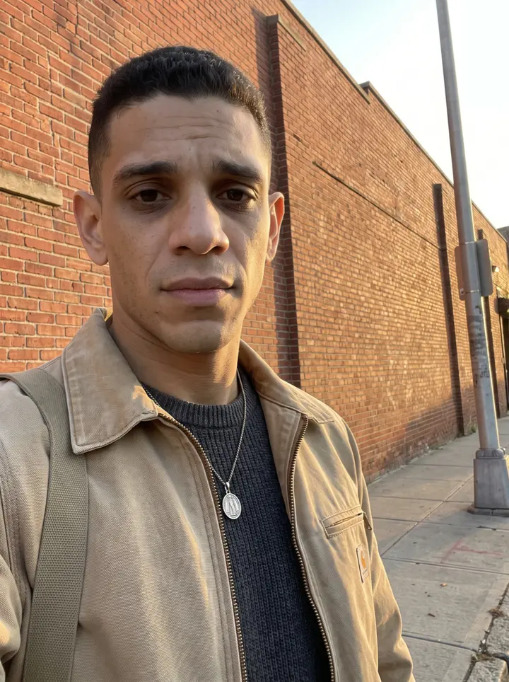 Fábio, AI character: outside the Newark Liberty employee parking area near a concrete bollard after his shift, terminal glass…
