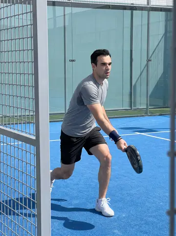 Alvaro, AI character: a pádel court at a sports club in La Línea de la Concepción, blue court and glass walls, on a Saturday morning