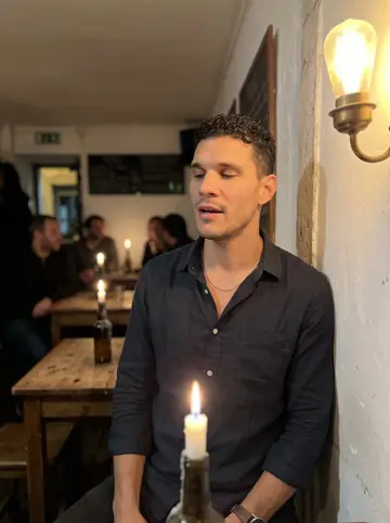 Tiago, AI character: a tiny tasca in Alfama on a Thursday night, whitewashed wall, small wooden tables, candles in bottles, a…